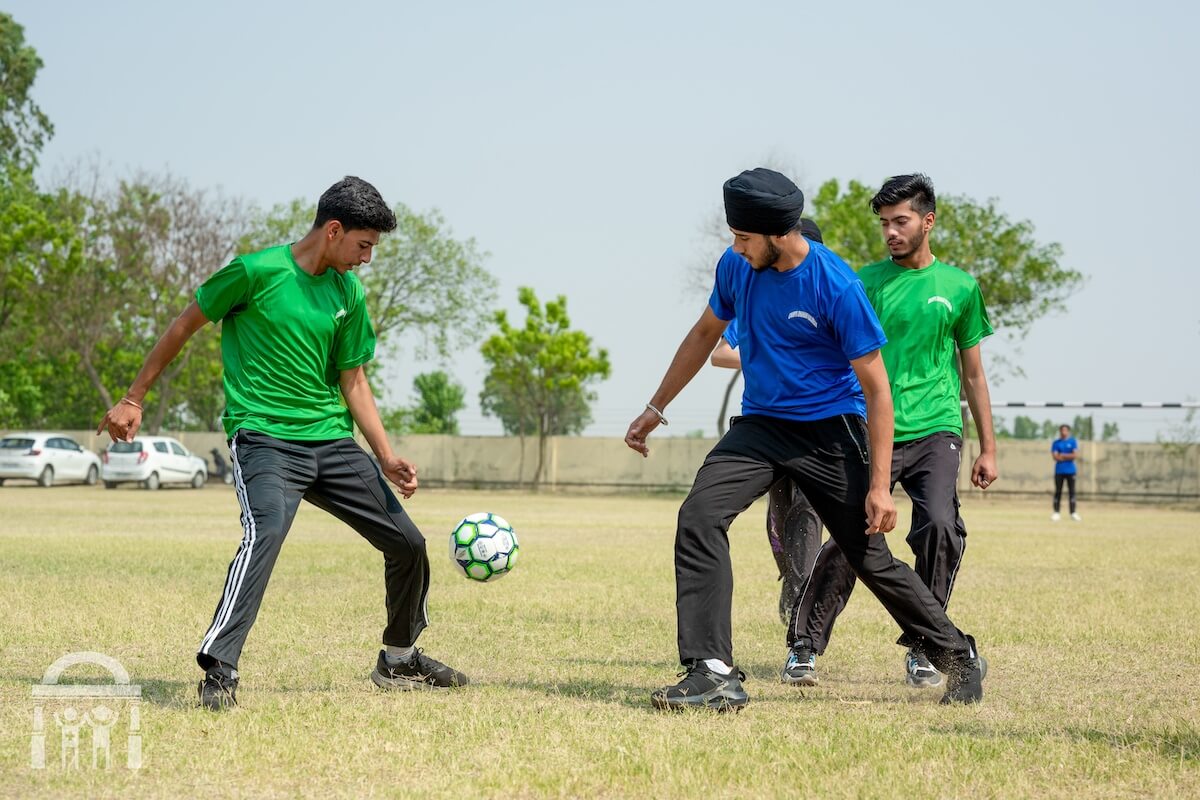 High school boys playing football at Guru Nanak Mission Public School Dhahan Kaleran