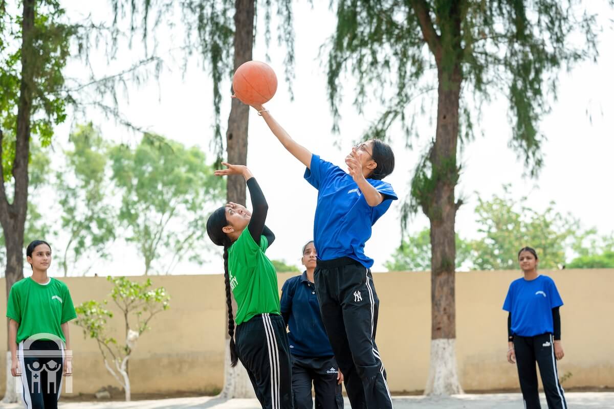 Girls playing basketball game at Guru Nanak Mission Public School Dhahan Kaleran in Punjab