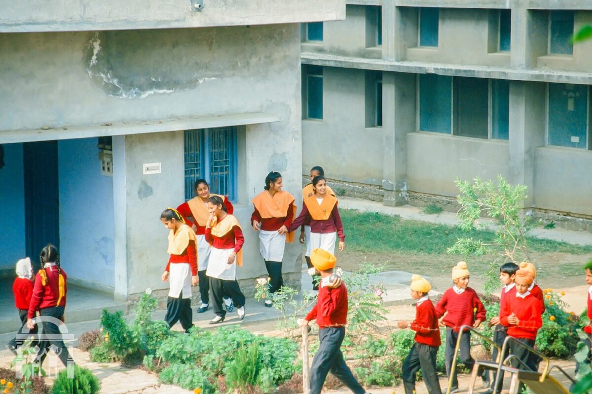Guru Nanak Mission Public School children in uniform walking on campus - historical photo - Dhahan Kaleran, Punjab