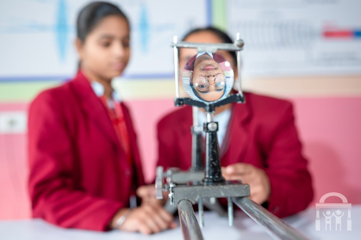 High school students using a lens in a physics lab at GN Public Secondary School in Dhahan Kaleran, SBS Nagar, Punjab, India