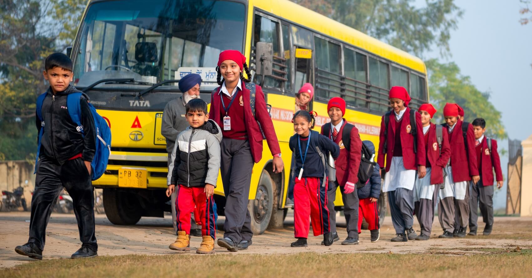 Primary school children walking to class off a bus at Guru Nanak Mission Public School in Dhahan Kaleran, SBS Nagar, Punjab, India