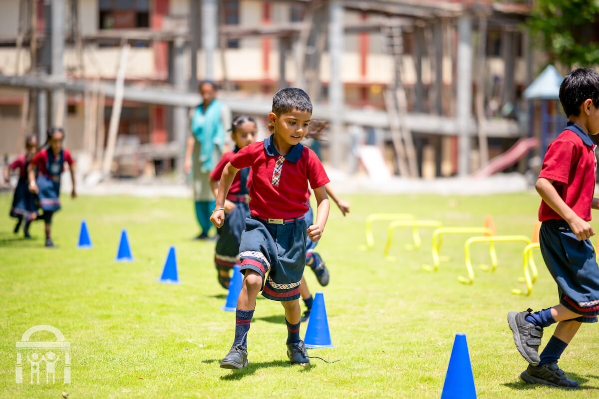 Primary school boys playing running game as outdoor activity at Guru Nanak Mission Public School