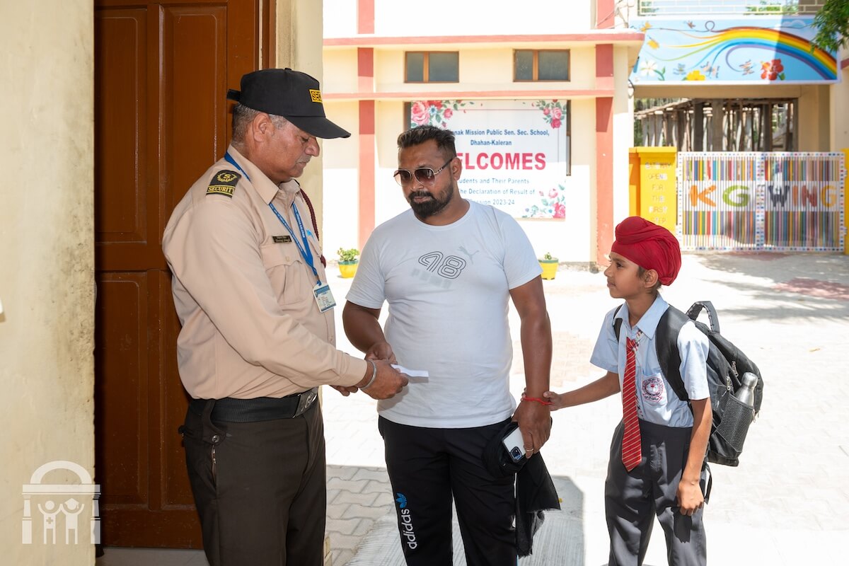 Security guard checking in parent at Guru Nanak Mission Public School in Dhahan Kaleran Punjab