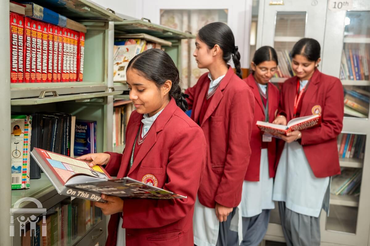 Students using reference books in library at GNM Public School in Dhahan Kaleran, Punjab, India